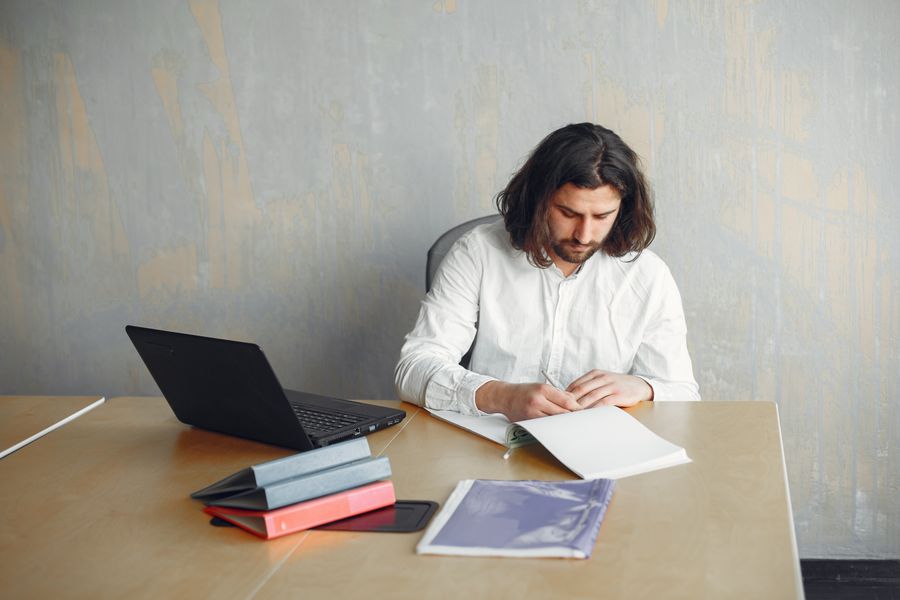 Professional working at a minimalist desk with technology