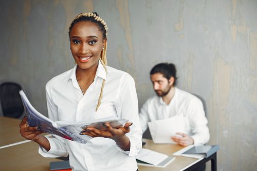 Free Smiling professionals in a modern office, showcasing diversity and collaboration. Stock Photo