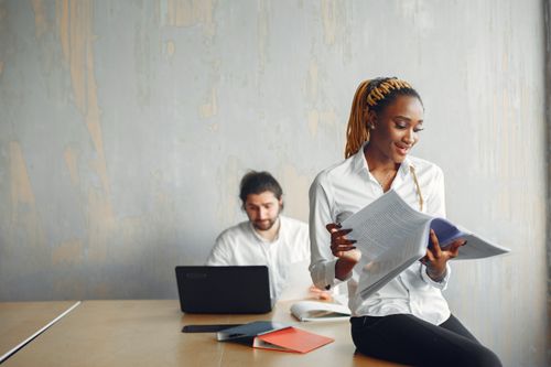 Free Two professionals working together in a modern office setting. Stock Photo