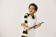 Man in Black and White Striped Long Sleeve Shirt Holding Black and Gray Stick