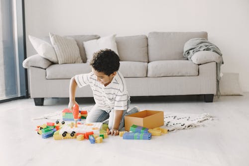 A Young Boy Enjoying Playing Toys