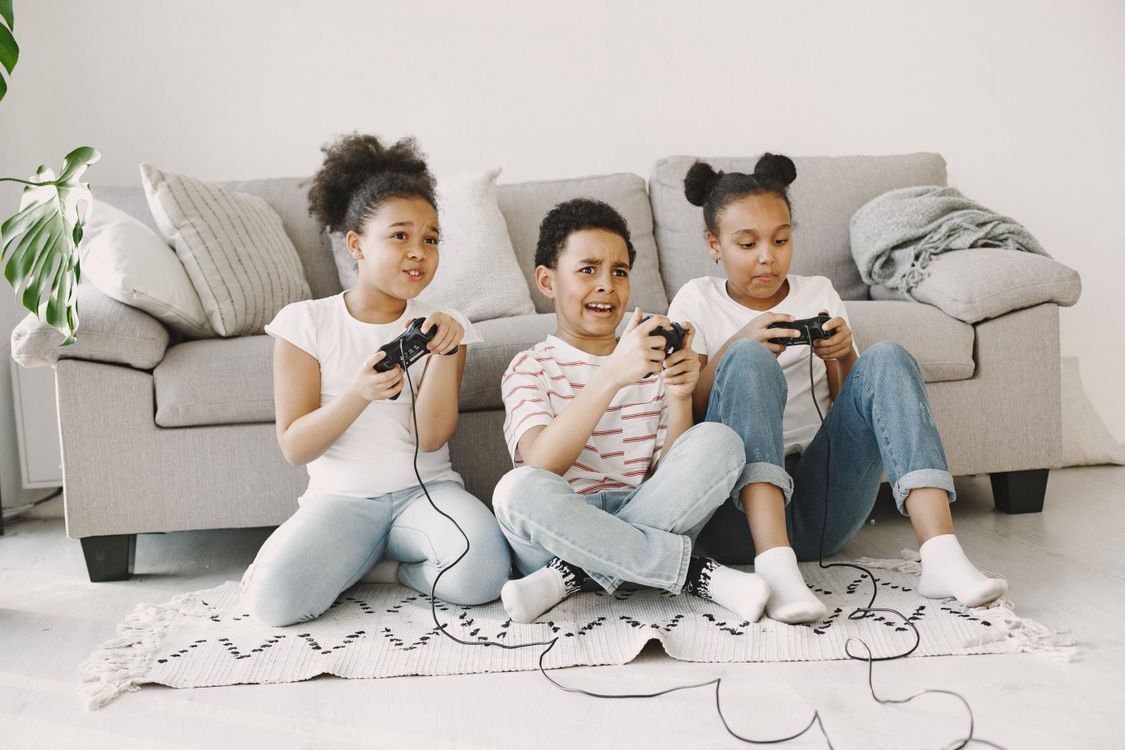 Kid Using Controller Kids Sitting on the Floor while Holding Controllers · Free Stock Photo