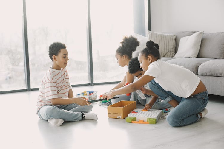 A Group Of Kids Playing Toys On The Floor