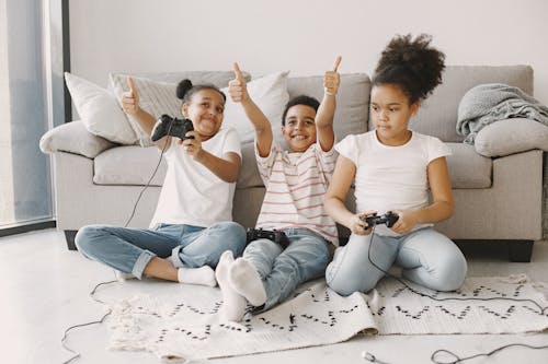 Kids Holding Black Game Controller