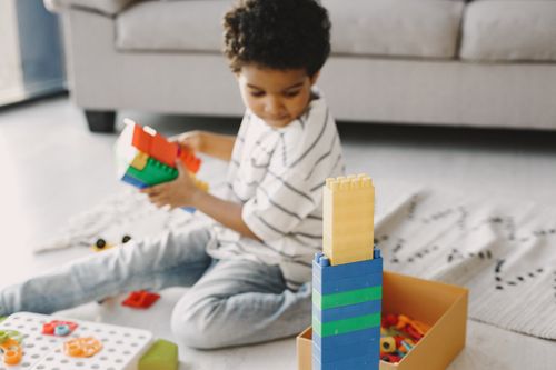 Boy playing with colorful building bricks