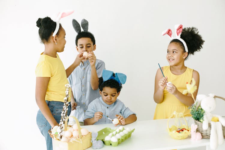 A Group Of Kids Painting Easter Eggs