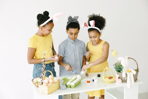 Kids Holding Green Paint Brushes