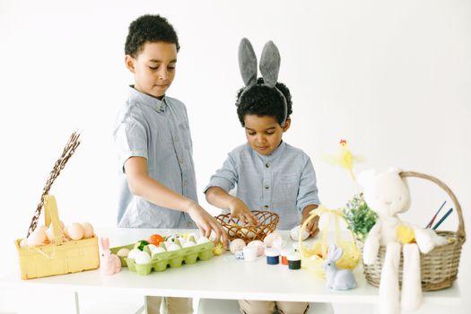 Kids Preparing Easter Baskets with Eggs