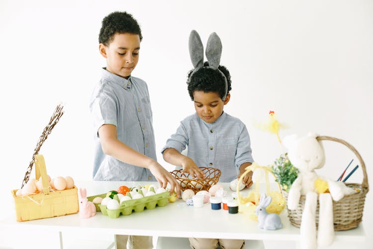 Kids Preparing Easter Baskets With Eggs