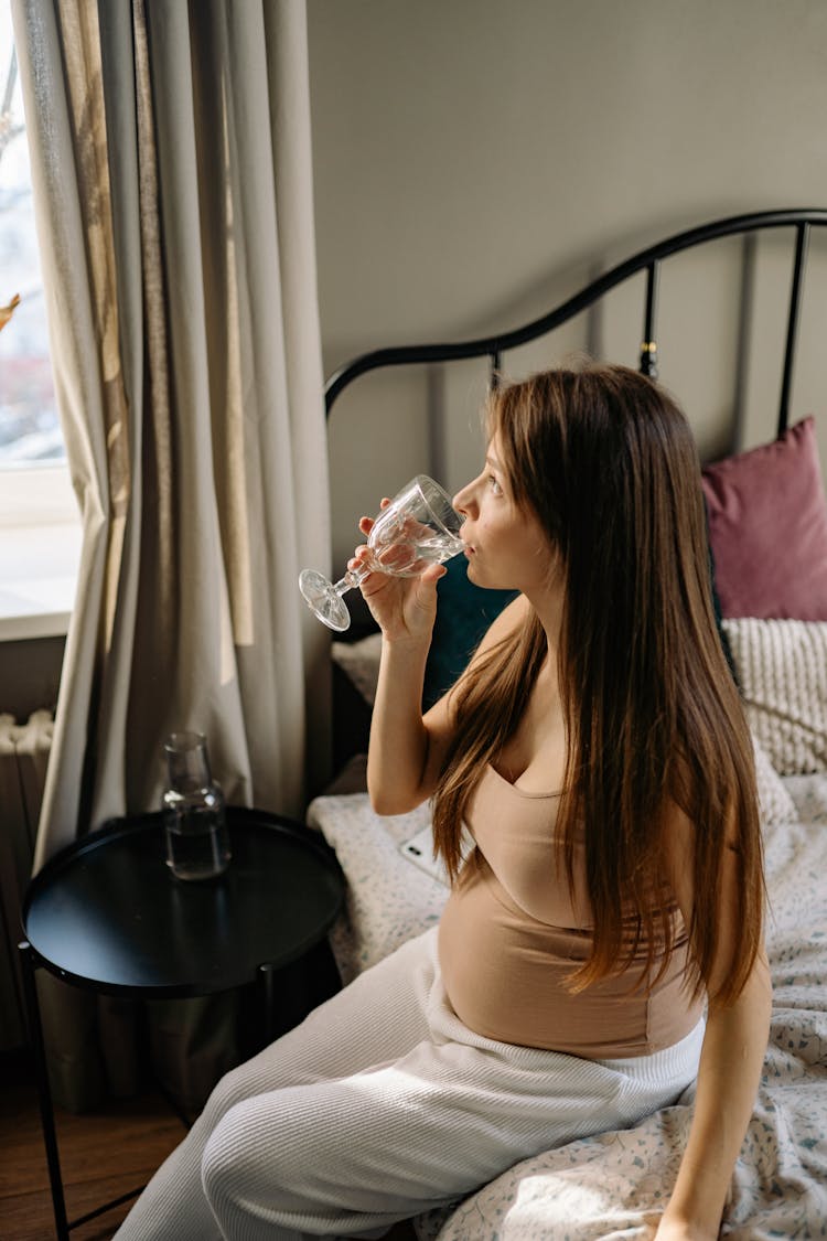 A Pregnant Woman Drinking Water