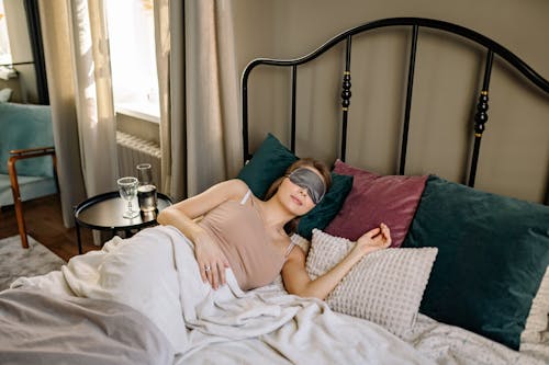 Free Woman in Pink Dress Lying on Bed Stock Photo