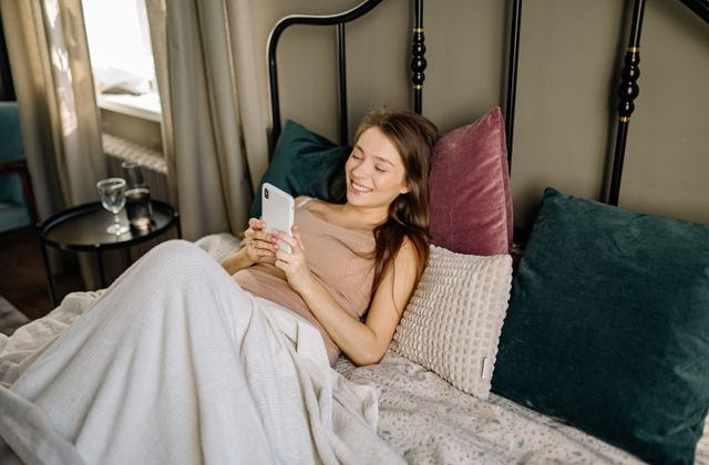 A person smiling at a surprise message on their phone