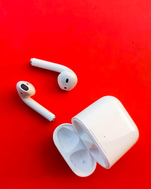 White Apple Airpods on Red Surface