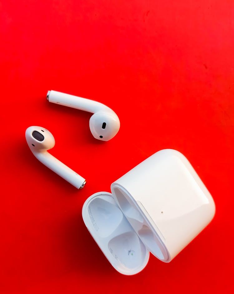 White Apple Airpods On Red Surface