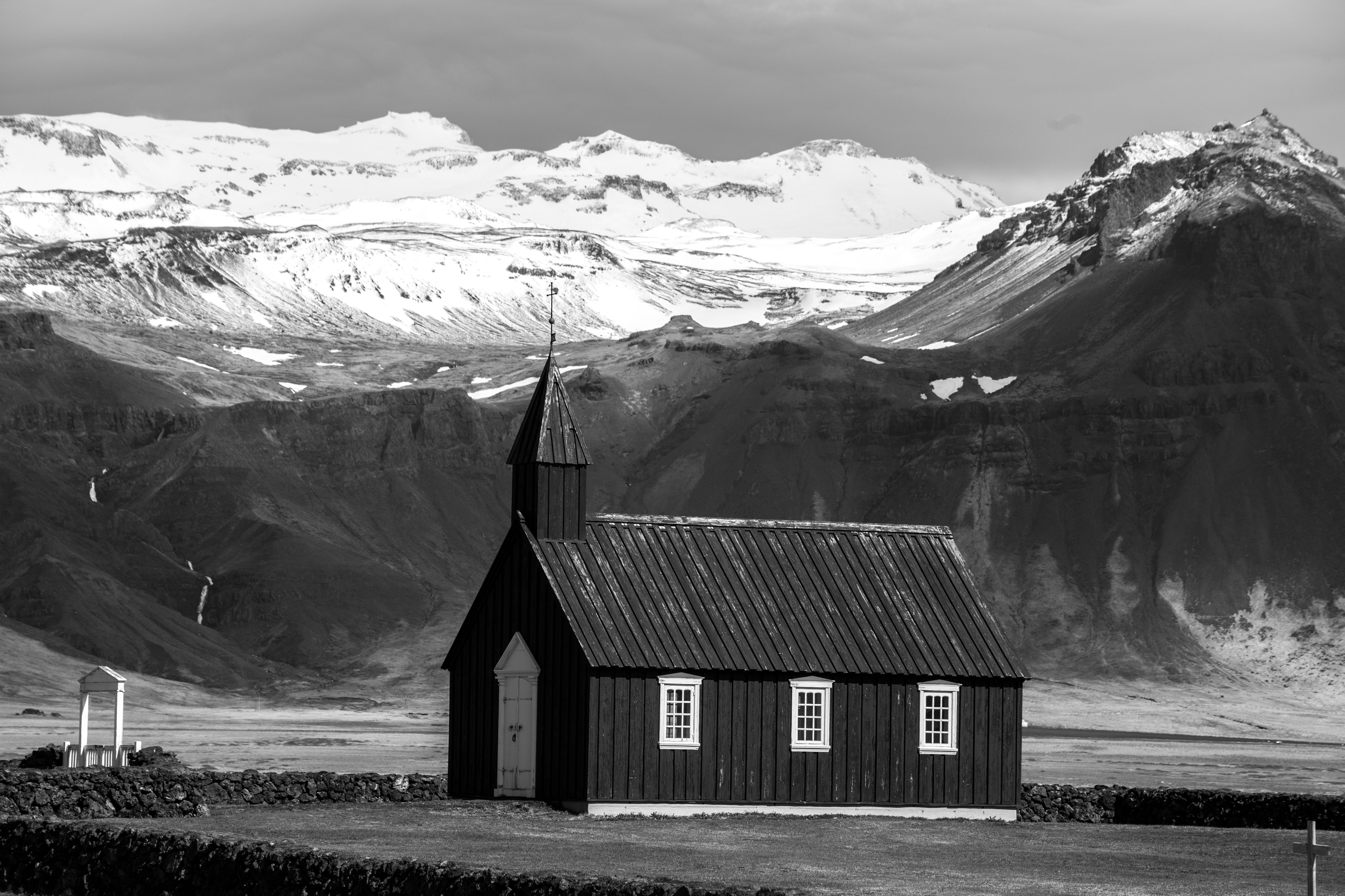 A Grayscale Photo of a House Near a Mountain · Free Stock Photo