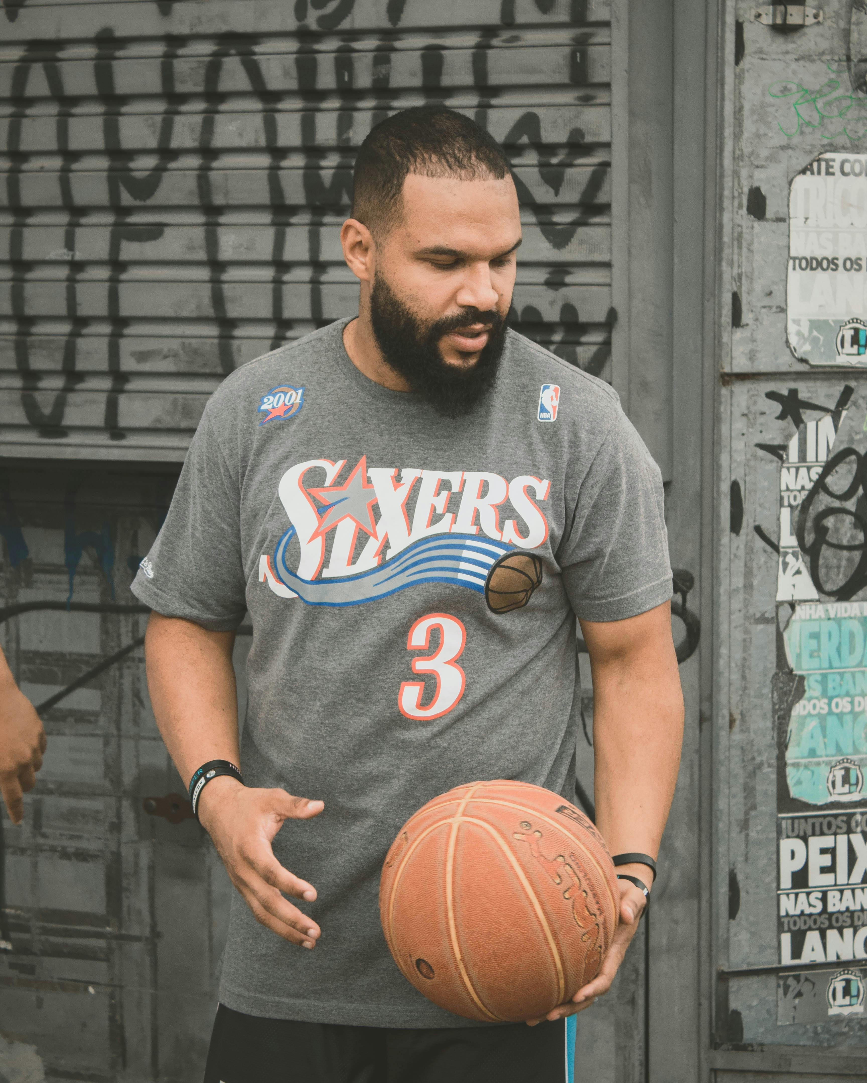 a bearded man holding a basketball