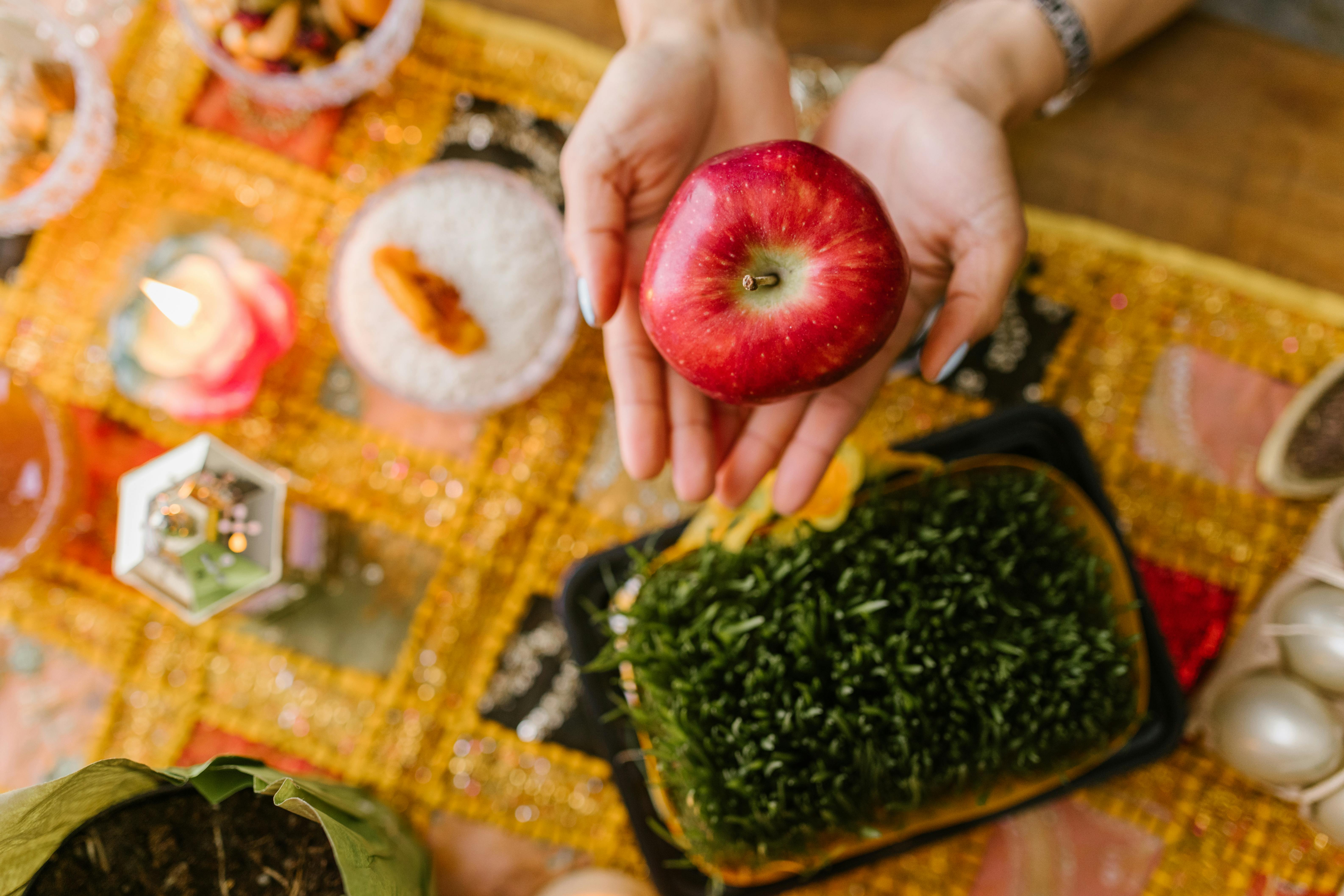 person holding a red apple