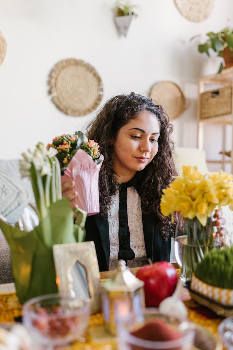 Woman Sitting By The Table With Flowers