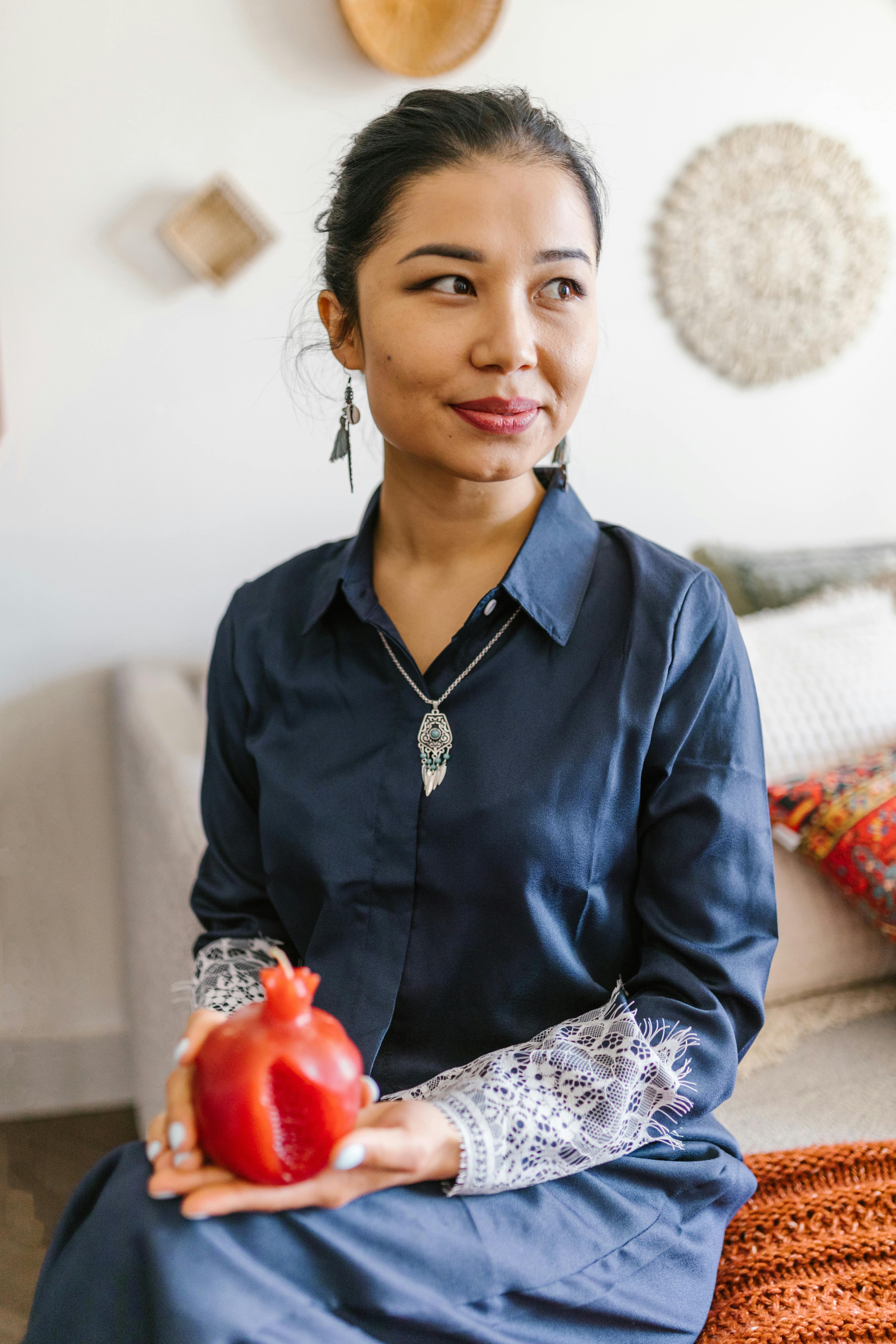 woman holding a red candle