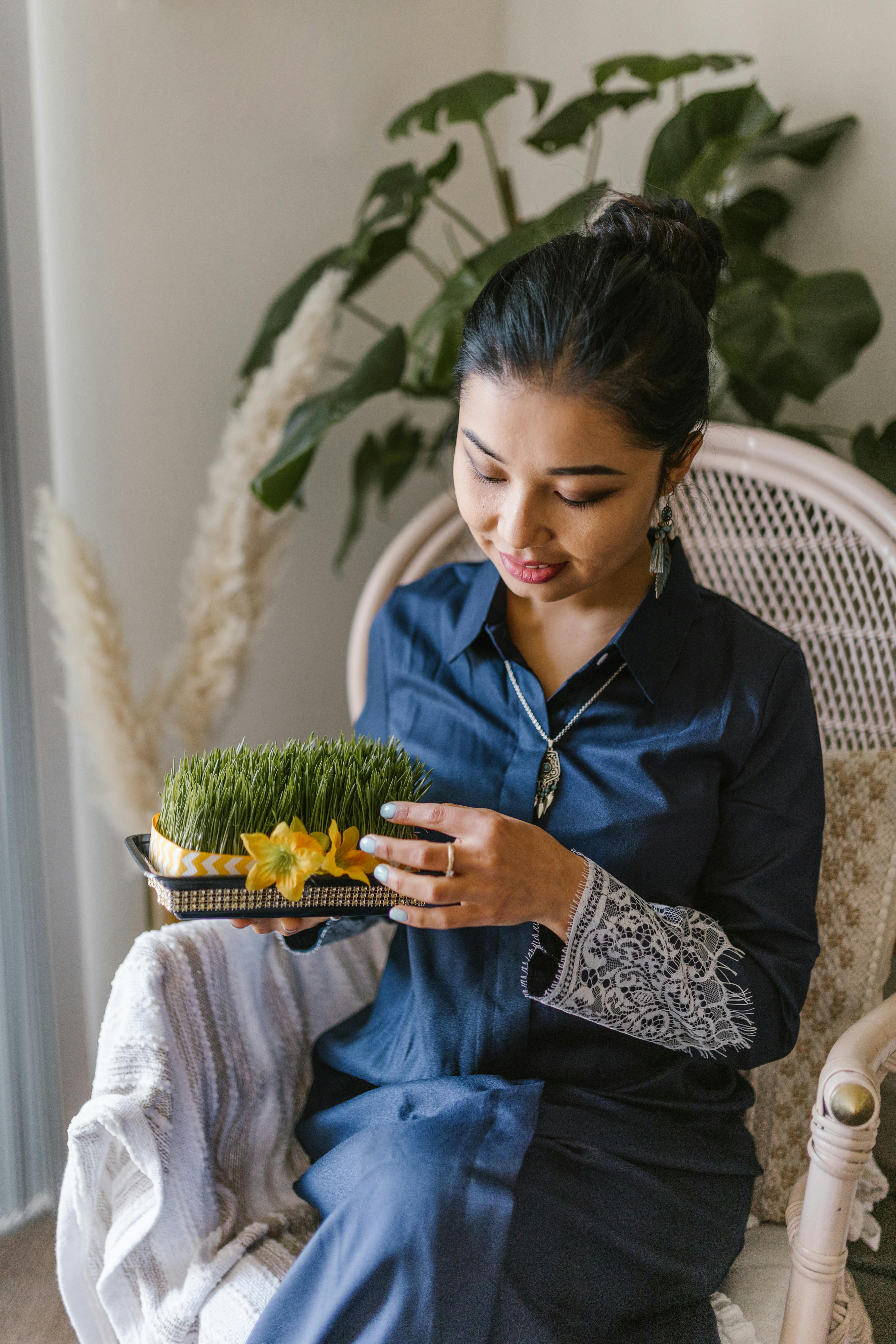 woman holding sprouts of wheat