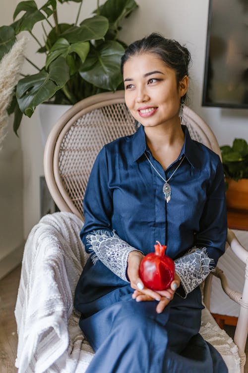 Woman Sitting On A Chair Holding A Candle