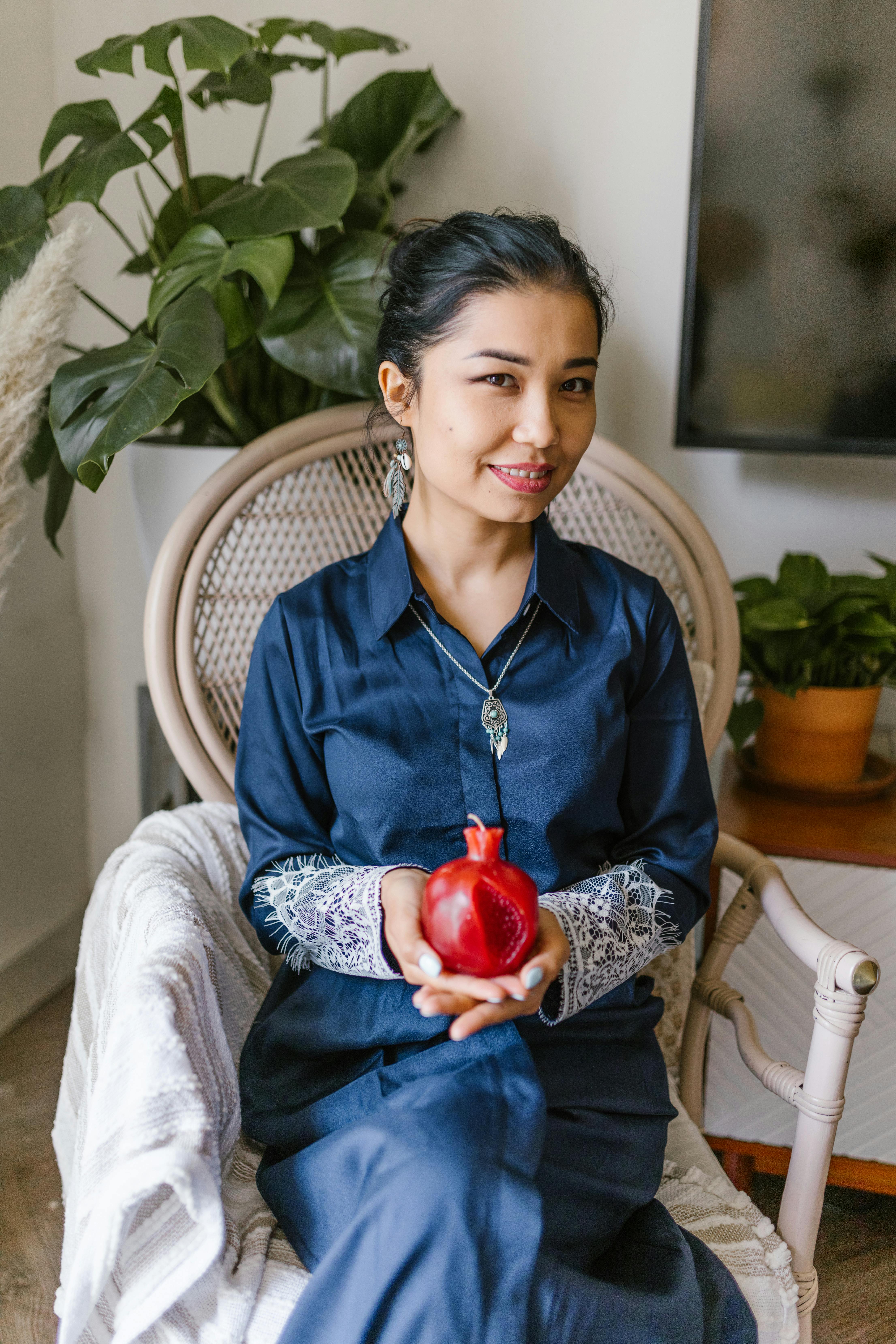 woman holding a red candle