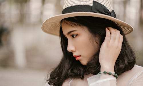 Shallow Focus Photography of Woman Wearing Brown Sun Hat