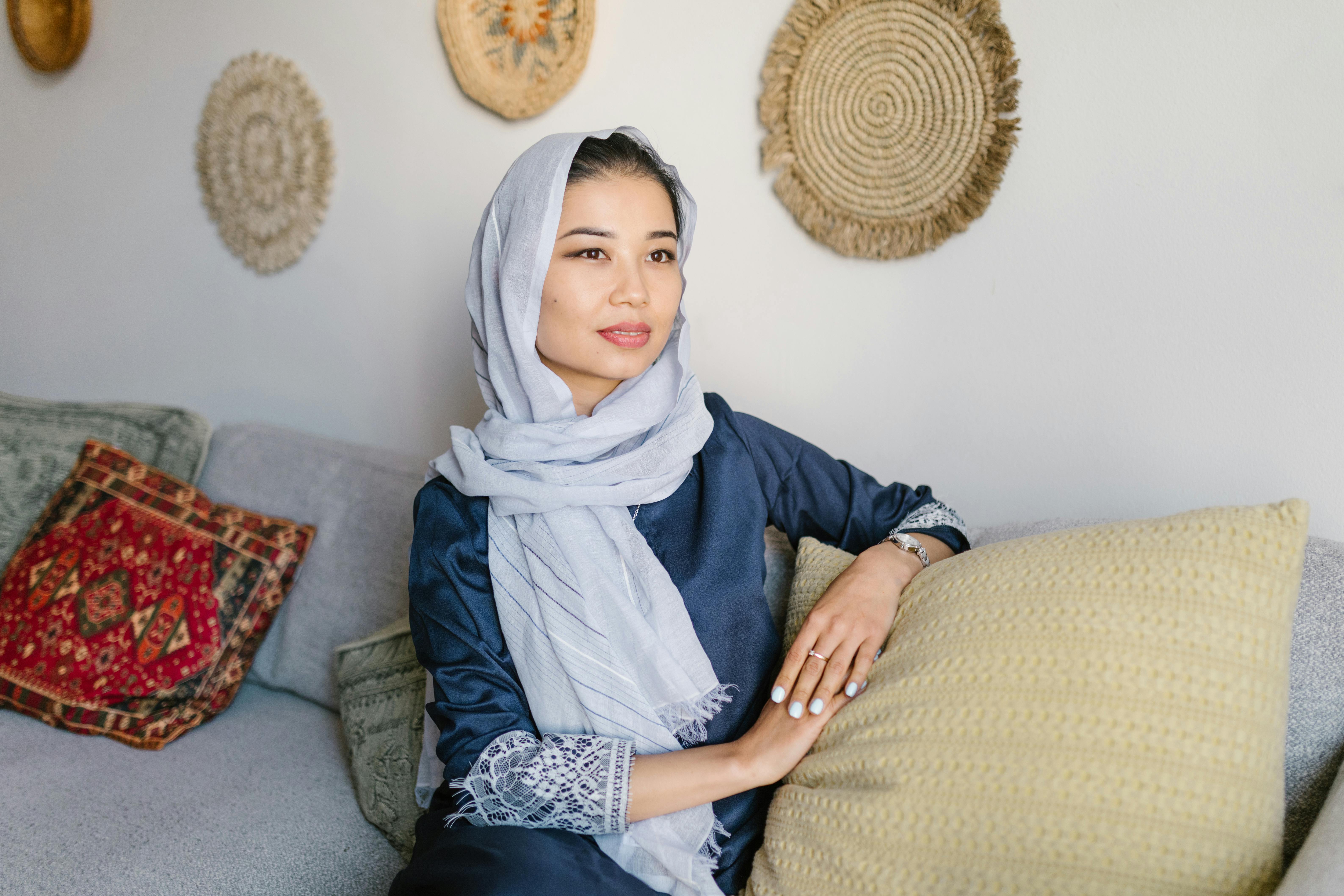 woman with headscarf sitting on couch