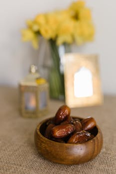 Elegant spring setup with dates, flowers, and lantern, ideal for Nowruz celebration imagery.