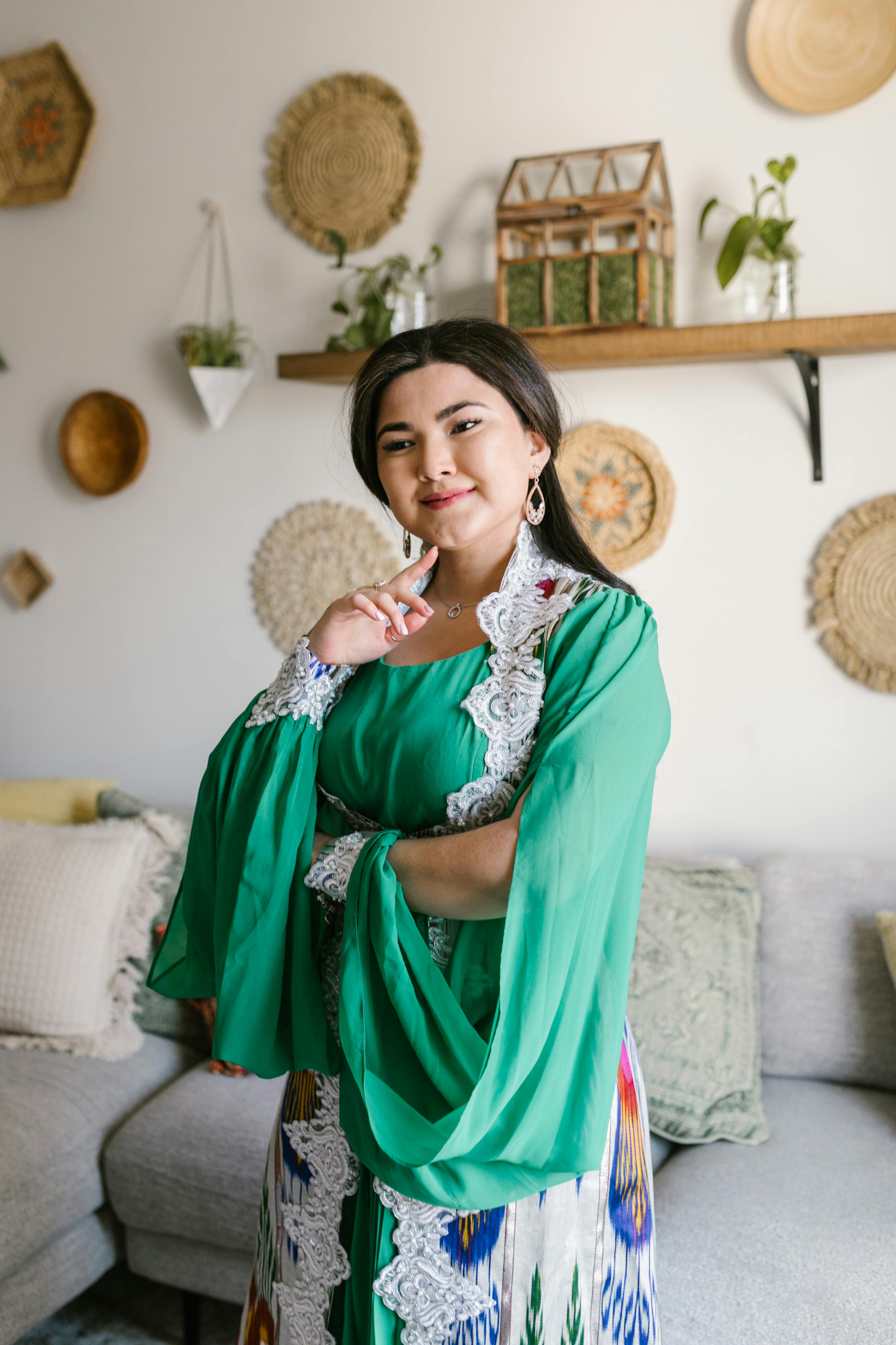 woman in green traditional dress with a smile