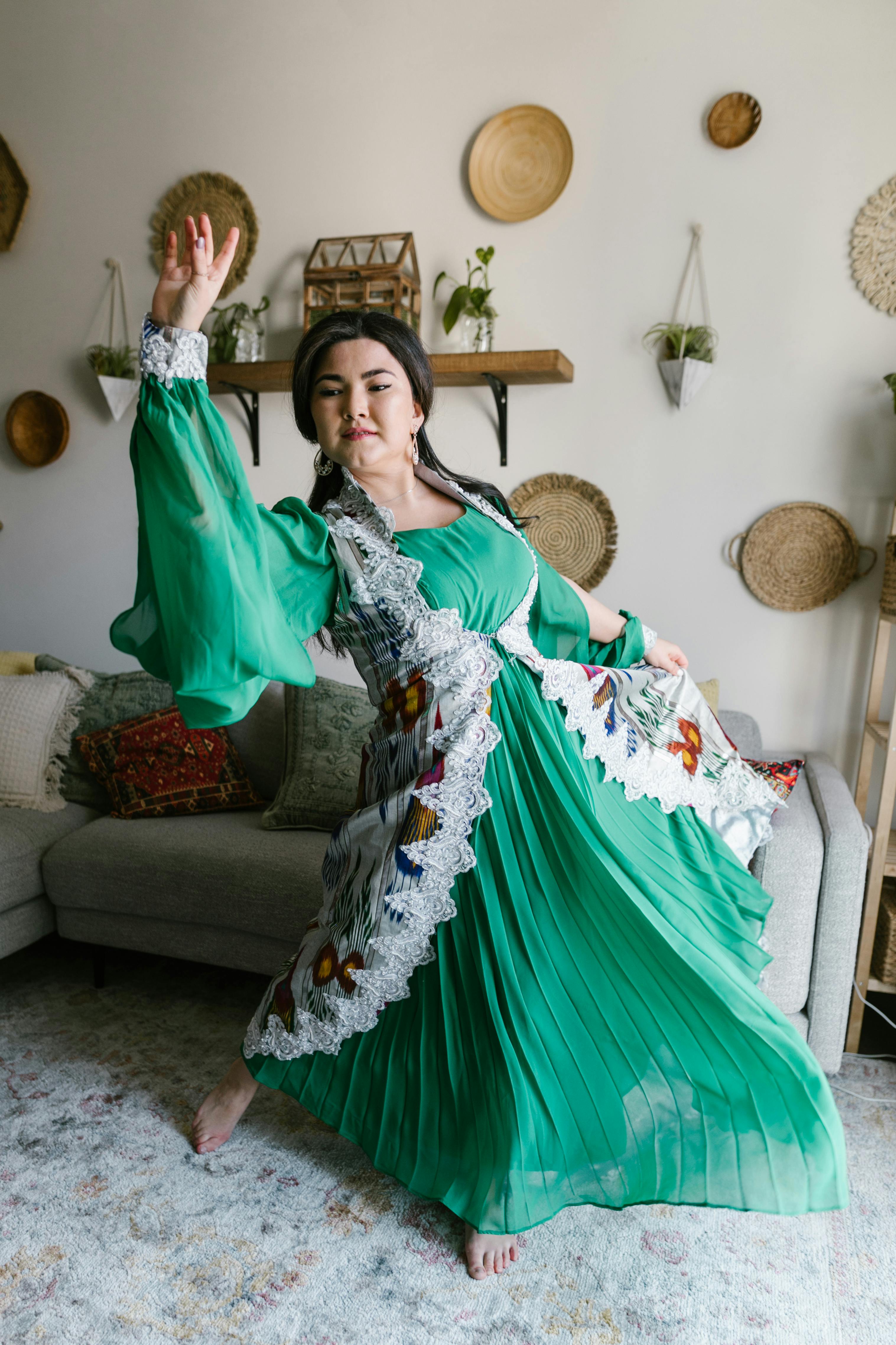 woman in green dress dancing in a room