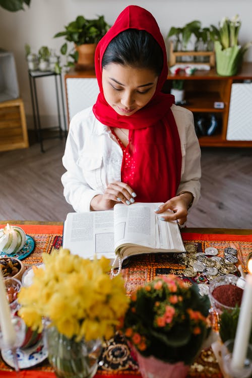 Woman in White Long Sleeve Shirt Reading A Book