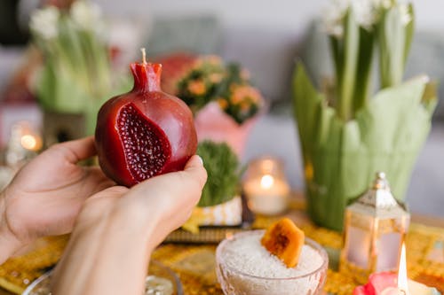 Person Holding A Red Candle