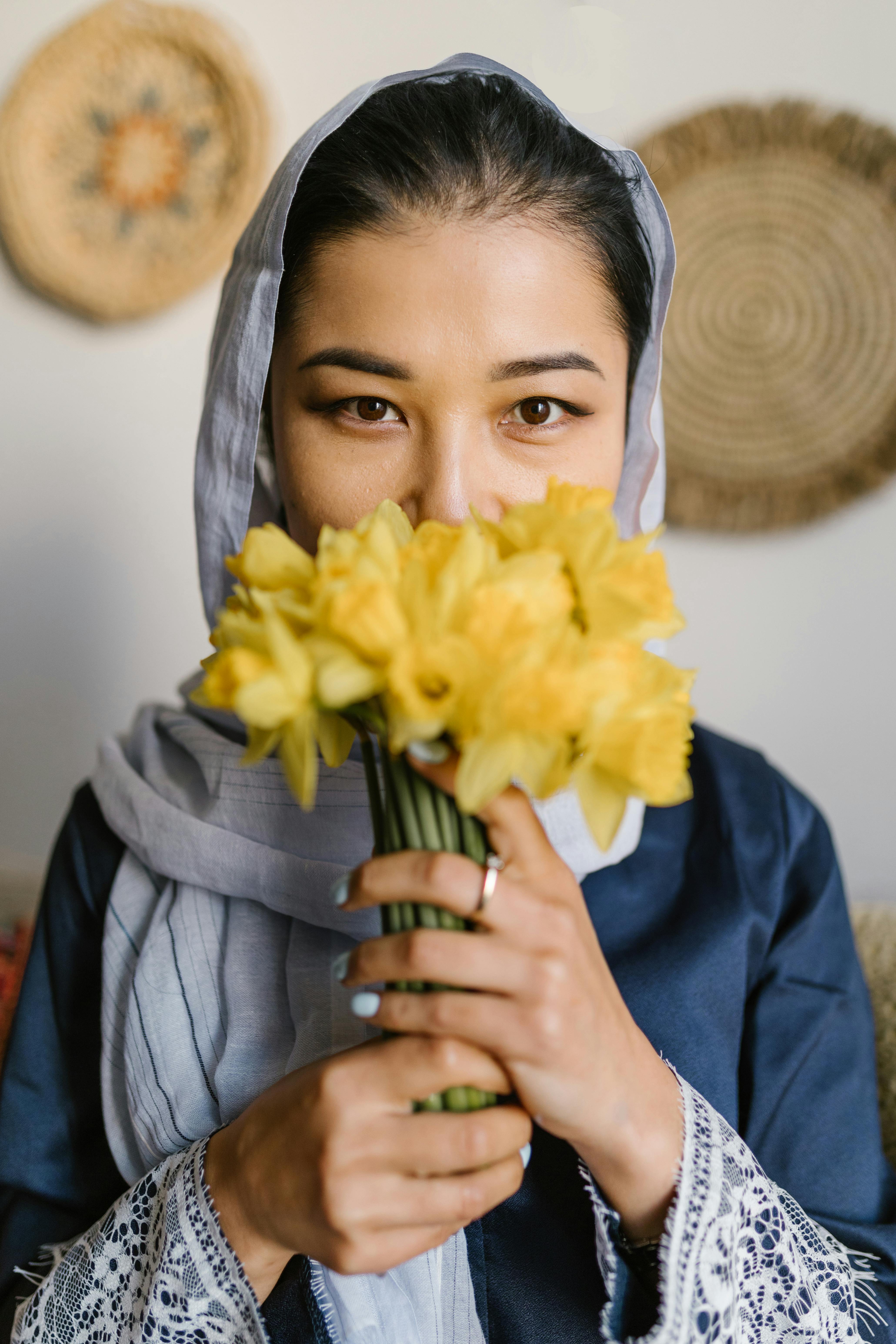 Portrait of a woman holding daffodils, exuding elegance and cultural tradition.