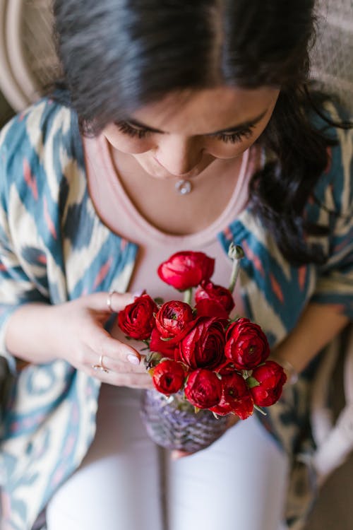 Woman Holding A Bunch Of Red Flowers