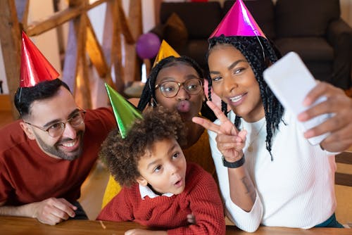 A Group of People Wearing Colorful Party Hat 