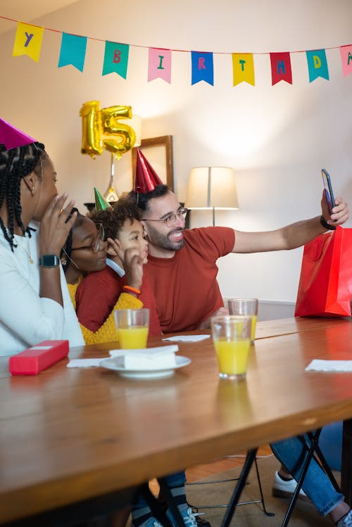 People Wearing Party Hats Having Groupfie 