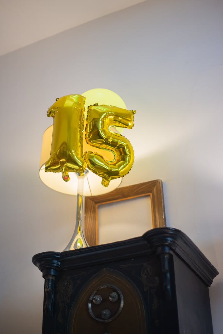 Gold Number Balloons On Top Of The Table