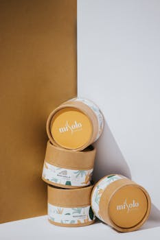 Stacked natural skincare packaging against a minimalist backdrop highlighting branding.