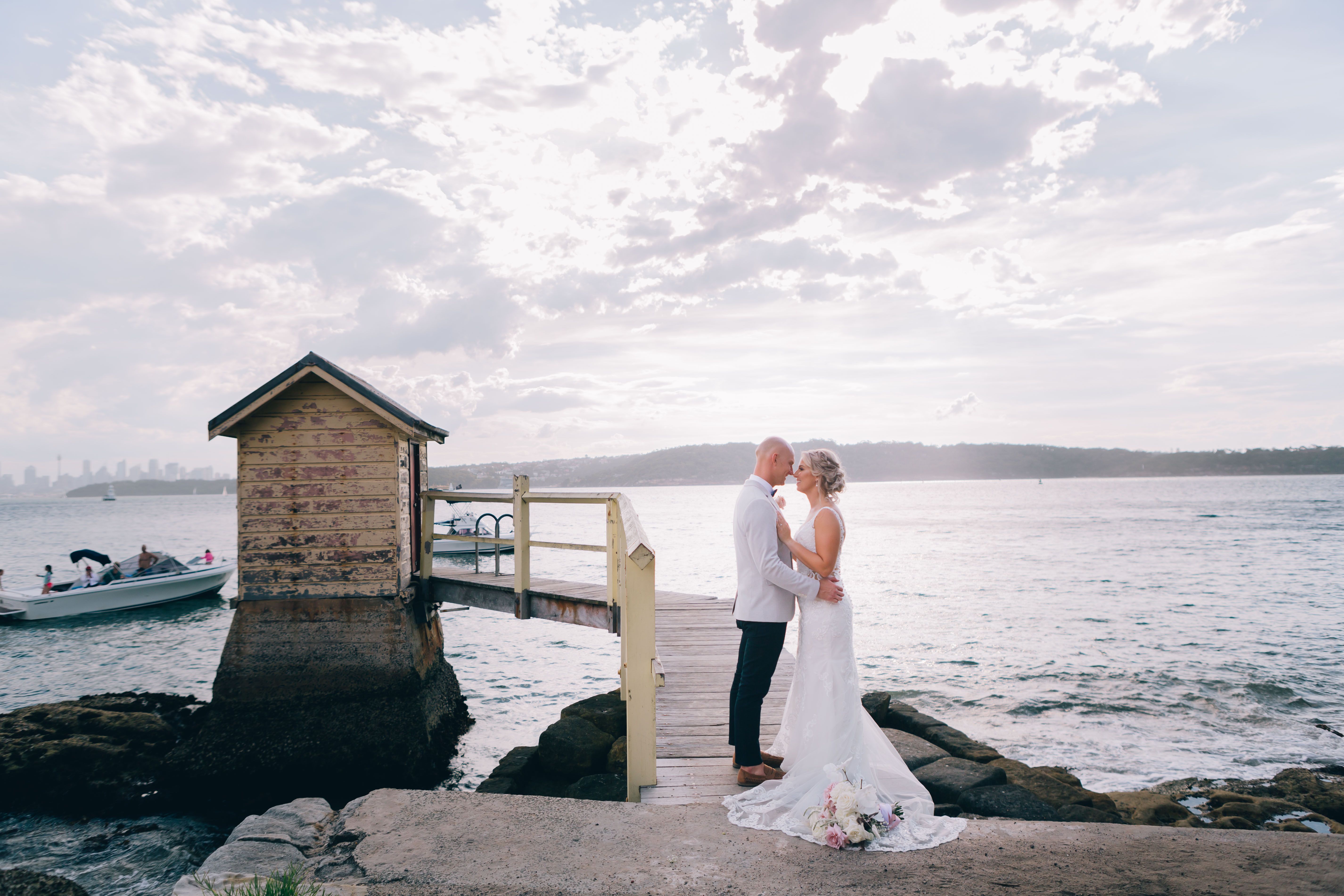 A beautiful wedding couple shares a moment by the pier at Watsons Bay, Australia.