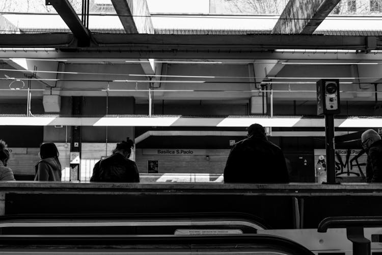 People Waiting For Train On Subway Station