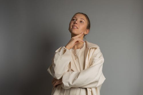 A Pretty Woman in Beige Long Sleeves Posing