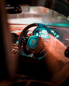 Close-up shot of a luxury sports car steering wheel, beautifully illuminated at night.