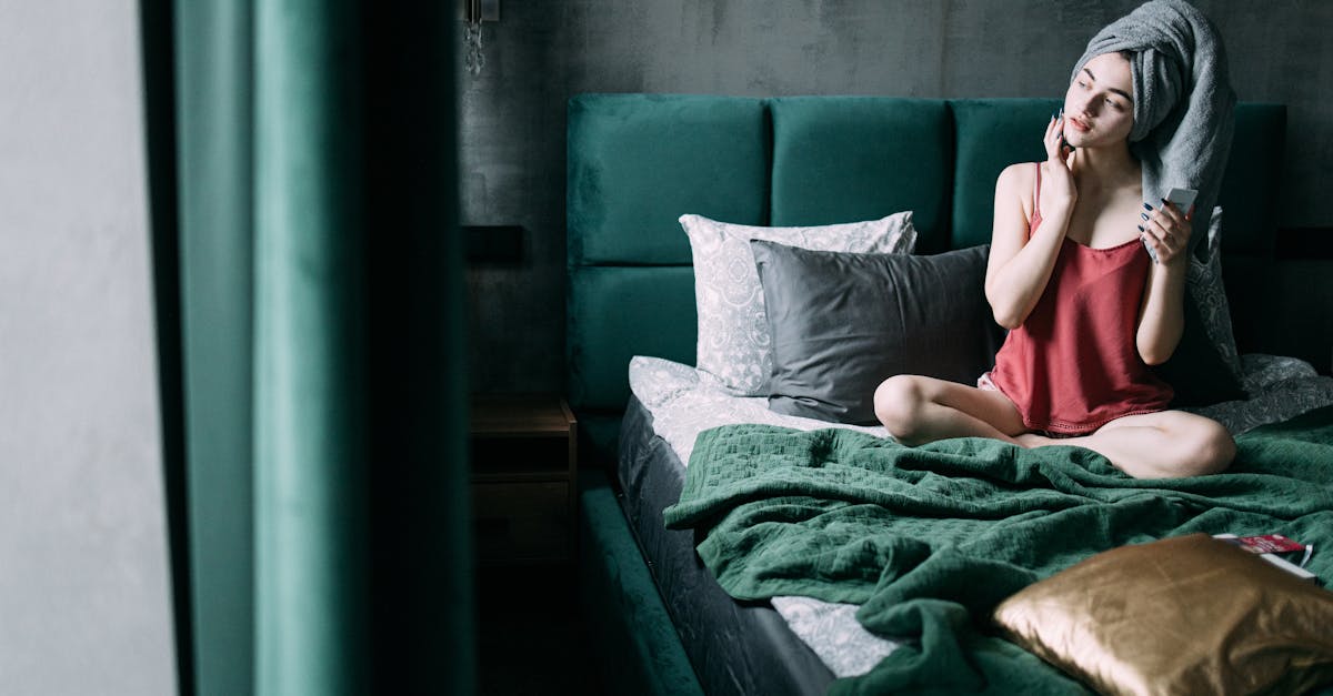 A person applying night cream before going to sleep.
