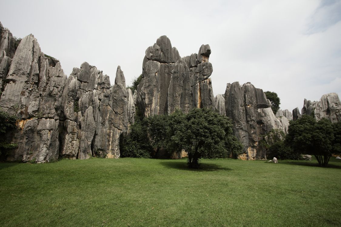 Gray Rock Formation Near the Grass Field · Free Stock Photo