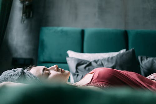 Free A Woman Lying on the Bed Stock Photo