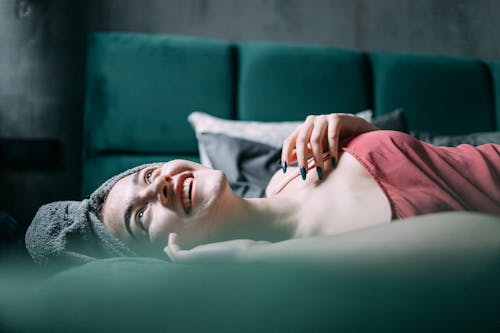 Free A Woman Lying on the Bed Stock Photo