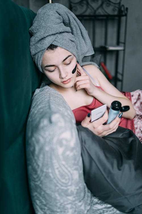 Woman in Head Towel Applying Face Mask 