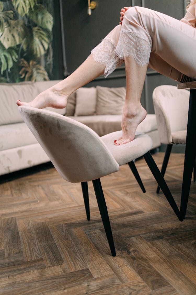 Photo Of A Person's Feet On A Chair