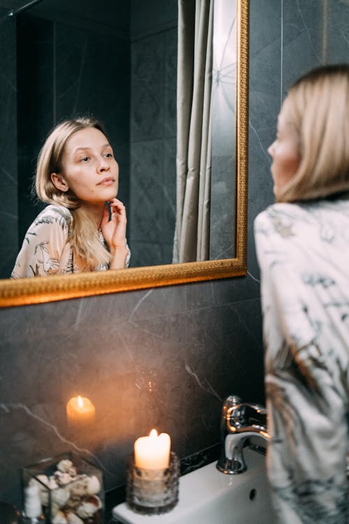 Beautiful Woman Looking at Her Reflection on The Mirror